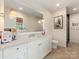 Bright bathroom with a double vanity, large mirror, and modern fixtures at 2343 Vernon Dr, Charlotte, NC 28211