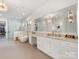 Main bathroom featuring dual vanities, a soaking tub, and a glass enclosed shower at 2343 Vernon Dr, Charlotte, NC 28211