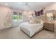 Charming pink bedroom with a large window, hanging chair, and a plush bed at 2343 Vernon Dr, Charlotte, NC 28211