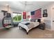 Inviting bedroom featuring a ceiling fan, decorative wall hangings, and a comfortable bed with stylish linens at 2343 Vernon Dr, Charlotte, NC 28211