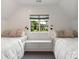 Cozy bedroom featuring a large window with a view, twin beds, and white shiplap walls at 2343 Vernon Dr, Charlotte, NC 28211