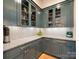 Chic butler's pantry with glass-front cabinets, marble countertops, and stylish brass accents for elegant storage at 2343 Vernon Dr, Charlotte, NC 28211