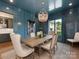 Elegant dining room featuring a decorative chandelier and stylish furnishings bathed in natural light at 2343 Vernon Dr, Charlotte, NC 28211