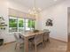 Dining room with shiplap walls, a wood table with seating for six, and a view to the pool outside at 2343 Vernon Dr, Charlotte, NC 28211