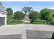 Long concrete driveway leading to a beautiful home, framed by trimmed shrubs and mature trees at 2343 Vernon Dr, Charlotte, NC 28211