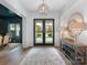 Elegant foyer featuring hardwood floors, a stylish mirror, and ample natural light, creating a welcoming entrance at 2343 Vernon Dr, Charlotte, NC 28211