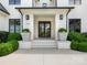 Grand entrance featuring a classic door with decorative planters and meticulously manicured landscaping at 2343 Vernon Dr, Charlotte, NC 28211