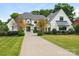 Elegant home boasts a manicured front yard, a circular driveway, and timeless architectural design at 2343 Vernon Dr, Charlotte, NC 28211