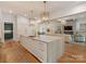 Stylish kitchen flows into a cozy living area, featuring a large island and modern stainless steel appliances at 2343 Vernon Dr, Charlotte, NC 28211