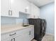 Well-equipped laundry room with white cabinets, modern appliances, and stylish tile flooring at 2343 Vernon Dr, Charlotte, NC 28211