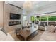 Open-concept living room featuring a fireplace, TV, modern chandelier, and sliding glass doors to the backyard at 2343 Vernon Dr, Charlotte, NC 28211