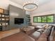 Spacious living room featuring a large sectional sofa, custom built-ins, and modern lighting at 2343 Vernon Dr, Charlotte, NC 28211