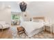 Cozy main bedroom with a textured headboard, stylish chandelier, and neutral decor at 2343 Vernon Dr, Charlotte, NC 28211