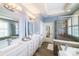 Bright bathroom with double vanity, glass shower, and separate soaking tub at 2355 Crockett Park Pl, Charlotte, NC 28203
