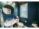 Stylish powder room featuring a pedestal sink, elegant mirror, and fresh decor at 2355 Crockett Park Pl, Charlotte, NC 28203
