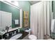 Charming bathroom with granite countertop, framed mirror, and shower with white shower curtain at 2355 Crockett Park Pl, Charlotte, NC 28203