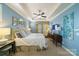 Light filled bedroom with blue walls, tray ceiling, fan and view of decorated wall at 2355 Crockett Park Pl, Charlotte, NC 28203