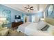 Light filled bedroom with blue walls, tray ceiling, fan and access to the bathroom at 2355 Crockett Park Pl, Charlotte, NC 28203