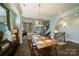Well-lit dining room with hardwood floors, a stylish chandelier, and seamless access to the living area at 2355 Crockett Park Pl, Charlotte, NC 28203