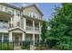 Charming townhome with two stories, front porch, balcony, fenced yard, and neutral-colored siding at 2355 Crockett Park Pl, Charlotte, NC 28203