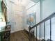 Elegant foyer with hardwood floors, staircase, stylish bench, and tasteful decor, creating a welcoming entrance at 2355 Crockett Park Pl, Charlotte, NC 28203