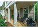 Inviting front porch with rocking chairs, elegant columns, and a cozy outdoor seating area at 2355 Crockett Park Pl, Charlotte, NC 28203