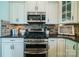 Updated kitchen with a gas range, stainless steel oven, microwave, and complementary white cabinets at 2355 Crockett Park Pl, Charlotte, NC 28203