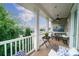 Inviting covered porch with an outdoor rug and comfortable seating, perfect for enjoying the fresh air at 2355 Crockett Park Pl, Charlotte, NC 28203