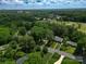 Expansive aerial view of the property nestled in a serene, wooded area, with meticulously maintained landscaping at 2601 Pinewood Rd, Gastonia, NC 28054