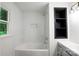 Newly renovated bathroom featuring a soaking tub, white subway tile, sleek fixtures, and a modern vanity at 2601 Pinewood Rd, Gastonia, NC 28054