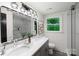 Bright bathroom featuring double sinks, sleek fixtures, and a glass-enclosed shower, offering modern convenience and style at 2601 Pinewood Rd, Gastonia, NC 28054