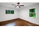 Light and airy bedroom with hardwood floors and large windows offering views of the surrounding landscape at 2601 Pinewood Rd, Gastonia, NC 28054