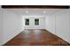Spacious bedroom with hardwood floors, two windows, and a closet, offering natural light and ample storage at 2601 Pinewood Rd, Gastonia, NC 28054