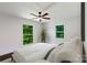 Bright bedroom with hardwood floors, a ceiling fan, large windows, and neutral colored accents at 2601 Pinewood Rd, Gastonia, NC 28054