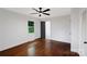 Bright bedroom showcasing hardwood floors, a ceiling fan, and a door to the en suite bath at 2601 Pinewood Rd, Gastonia, NC 28054
