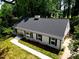 Beautifully renovated home featuring a classic white exterior, black shutters, and a well-manicured lawn at 2601 Pinewood Rd, Gastonia, NC 28054