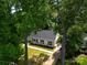 Beautifully renovated home featuring a classic white exterior, black shutters, and a well-manicured lawn at 2601 Pinewood Rd, Gastonia, NC 28054