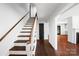 Foyer with wooden stairs and matching trim, and hardwood floors adding classic charm to the home's entry at 2601 Pinewood Rd, Gastonia, NC 28054