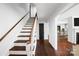 Elegant hallway with hardwood floors and stairs, leading to various areas of the home with seamless transitions at 2601 Pinewood Rd, Gastonia, NC 28054