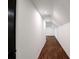 Hallway with hardwood floors and white walls leads to a bright space, perfect for a functional and stylish home at 2601 Pinewood Rd, Gastonia, NC 28054
