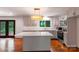 Renovated kitchen featuring gray cabinetry, island with seating, stainless appliances, and a window overlooking the backyard at 2601 Pinewood Rd, Gastonia, NC 28054
