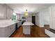 Bright kitchen featuring gray cabinets, stainless steel appliances, an island with white countertop, and hardwood floors at 2601 Pinewood Rd, Gastonia, NC 28054