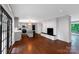 Open kitchen boasts gray cabinets, stainless appliances, and center island with bar seating and white brick fireplace at 2601 Pinewood Rd, Gastonia, NC 28054