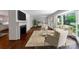 Bright living room features hardwood floors, fireplace, large windows, and neutral-toned furniture at 2601 Pinewood Rd, Gastonia, NC 28054