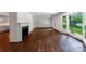 Bright living room featuring hardwood floors, a fireplace, and expansive windows with views of the outdoors at 2601 Pinewood Rd, Gastonia, NC 28054