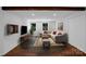 Cozy living room features a sectional sofa, television and hardwood floors, creating a welcoming and comfortable living space at 2601 Pinewood Rd, Gastonia, NC 28054