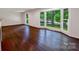 Living room showcasing gleaming hardwood floors and abundant natural light from large windows, creating a warm ambiance at 2601 Pinewood Rd, Gastonia, NC 28054