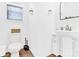 Clean, well-lit bathroom with white fixtures, wood-look flooring, and a minimalist design at 3153 Pinehills Way, Mount Holly, NC 28120