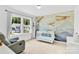 Charming Bedroom featuring a crib, comfortable armchair, and airplane-themed wall decor at 3153 Pinehills Way, Mount Holly, NC 28120
