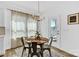 Dining room with table and 4 chairs. Glass door to the outside brings in natural light at 3153 Pinehills Way, Mount Holly, NC 28120